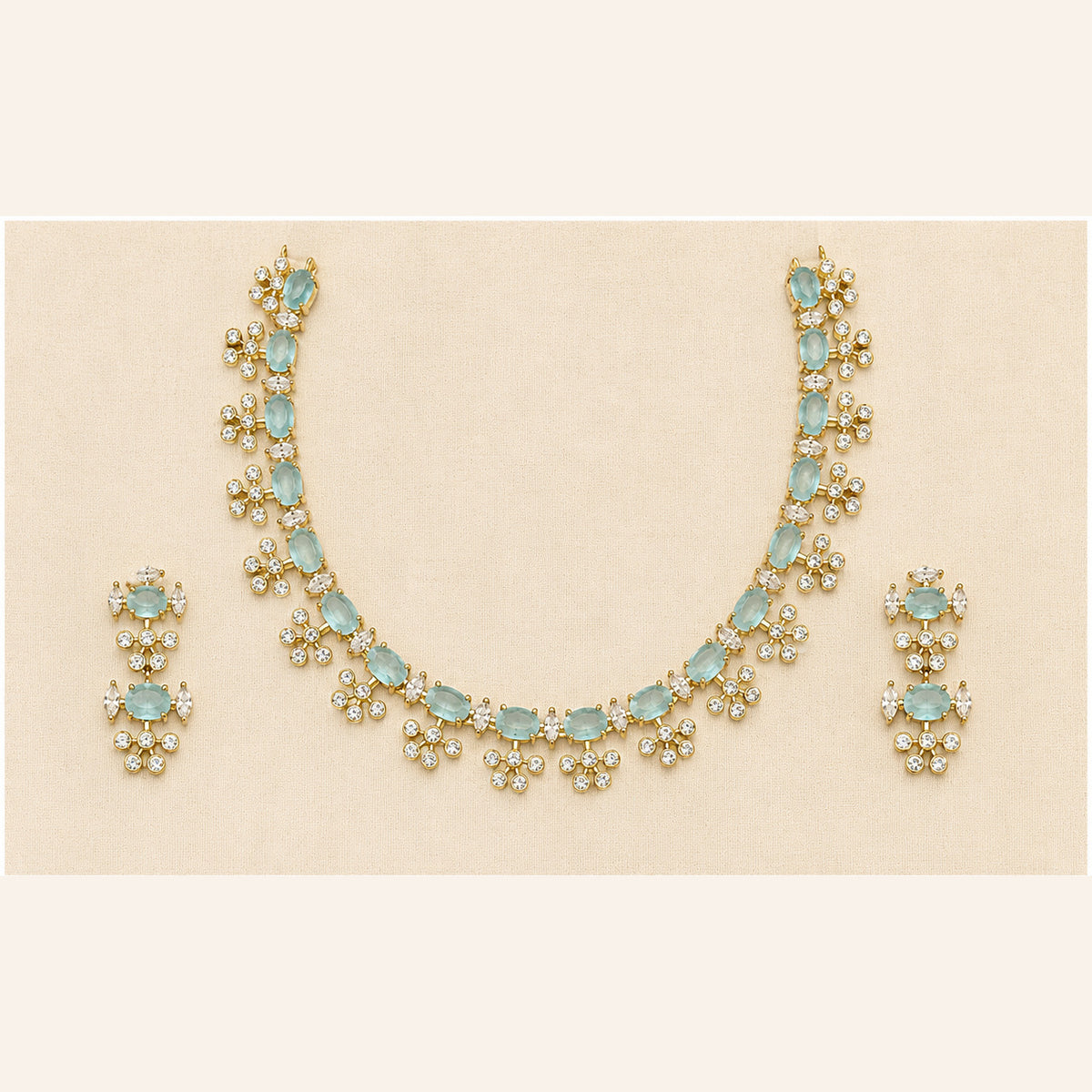 Alai gold-tone aqua blue stone necklace set with crystal accents and matching statement earrings